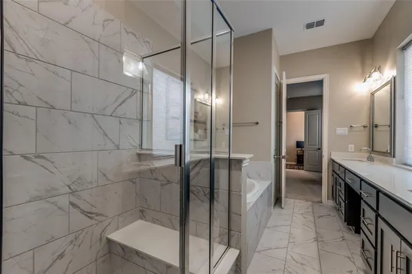 a bathroom with a mirror and a shower