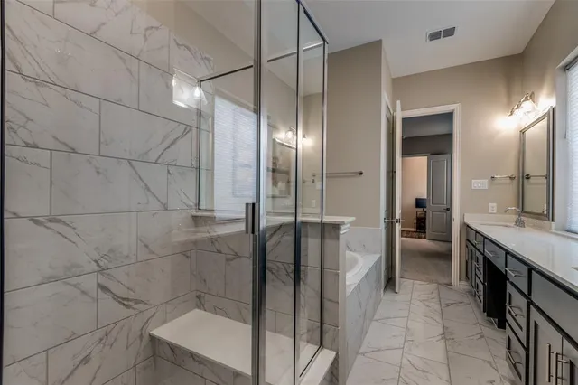 a bathroom with a mirror and a shower
