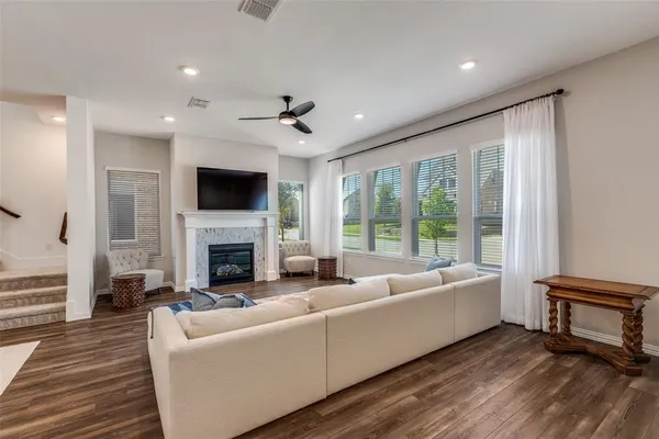 a living room with furniture a fireplace and a flat screen tv