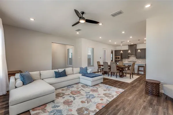 a living room with furniture and kitchen view