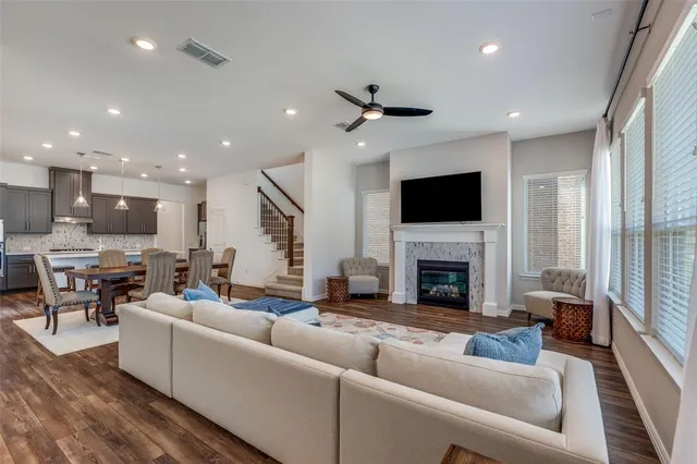 a living room with furniture a fireplace and a flat screen tv