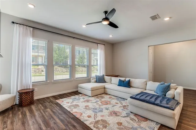 a living room with furniture and a large window
