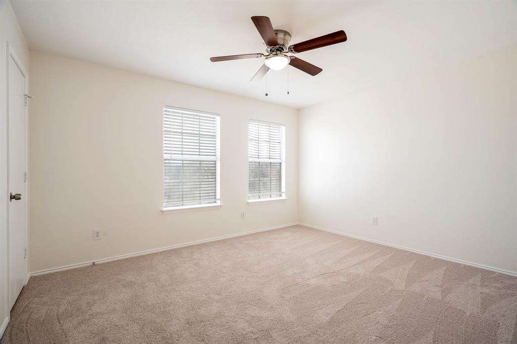 1626 White Oak Road Anna, TX 75409 - Photo 19 of 30 an empty room with a window and a fan