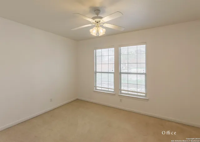 a kitchen with sink a refrigerator and wooden cabinets