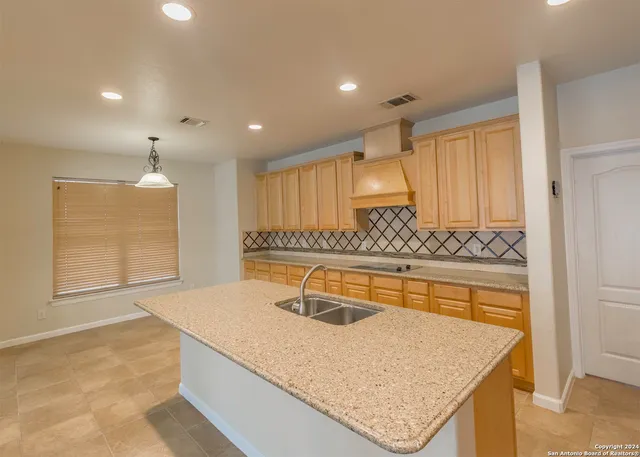a kitchen with a sink a counter space and appliances