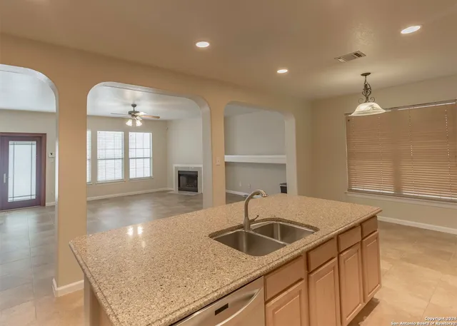 an open kitchen with cabinets and wooden floor