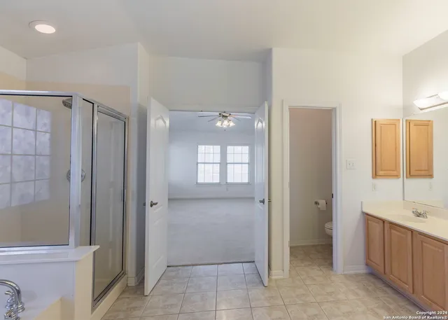 a bathroom with a tub sink and mirror