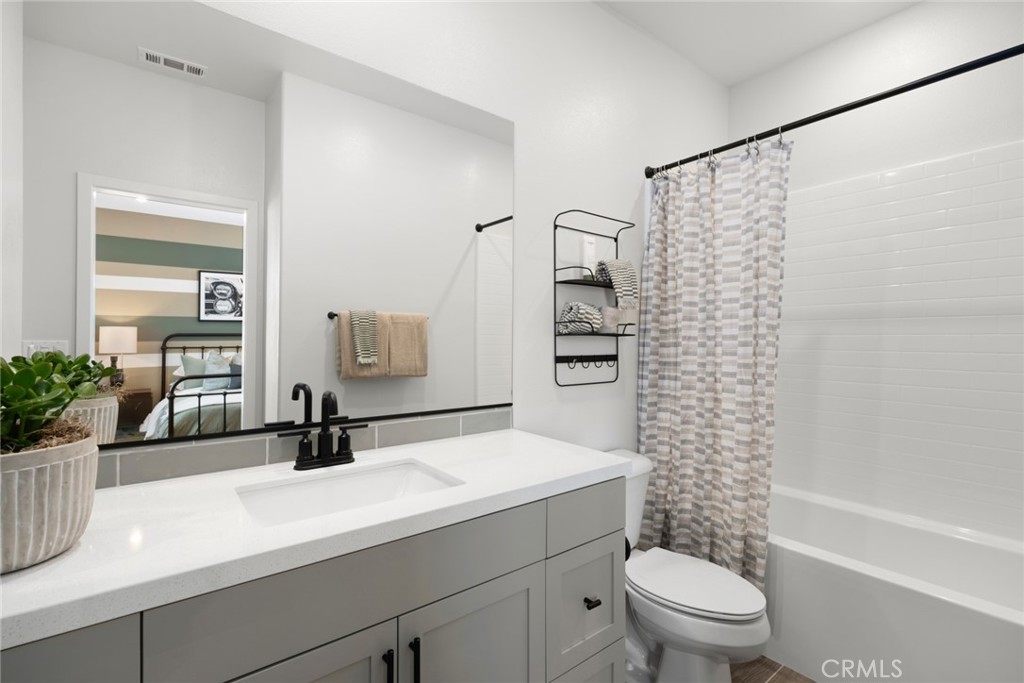 12250 Mirasol Loop, Unit H El Monte, CA 91732 - Photo 11 of 18 a bathroom with a sink a toilet and shower