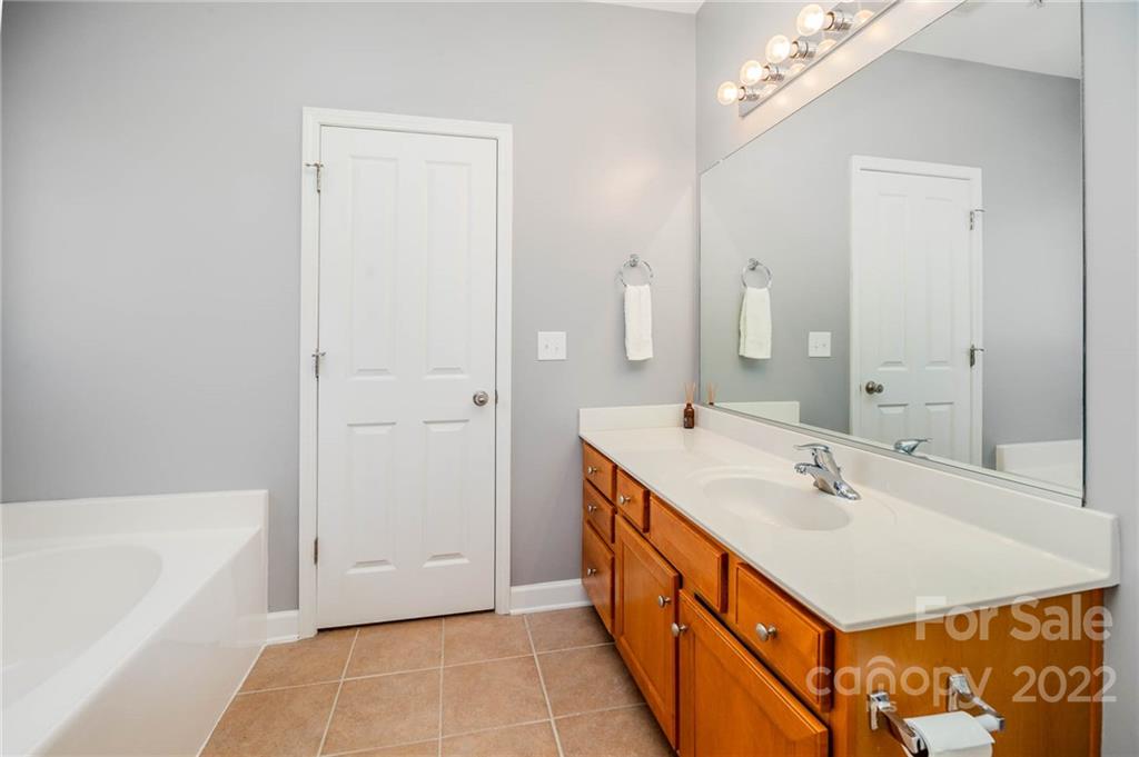 4156 Walker Road Charlotte, NC 28211 - Photo 16 of 24 a bathroom with a sink a tub and a mirror