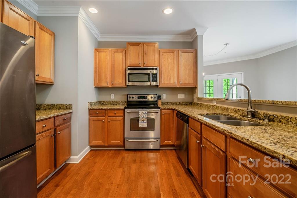 4156 Walker Road Charlotte, NC 28211 - Photo 8 of 24 a kitchen with granite countertop a stove top oven microwave and sink