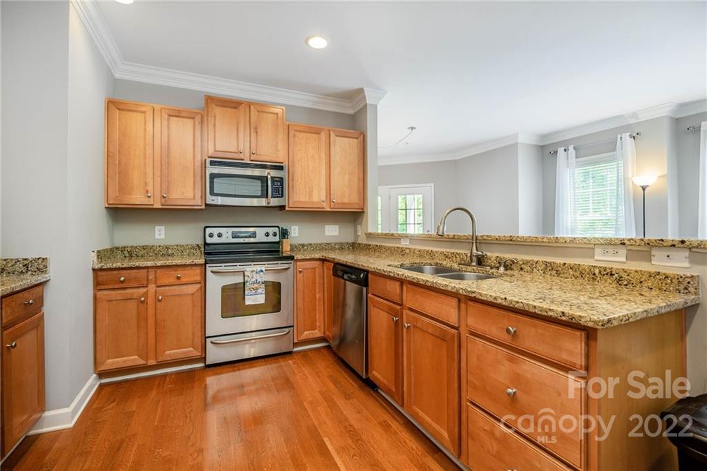 4156 Walker Road Charlotte, NC 28211 - Photo 9 of 24 a kitchen with stainless steel appliances granite countertop a stove a sink and a microwave