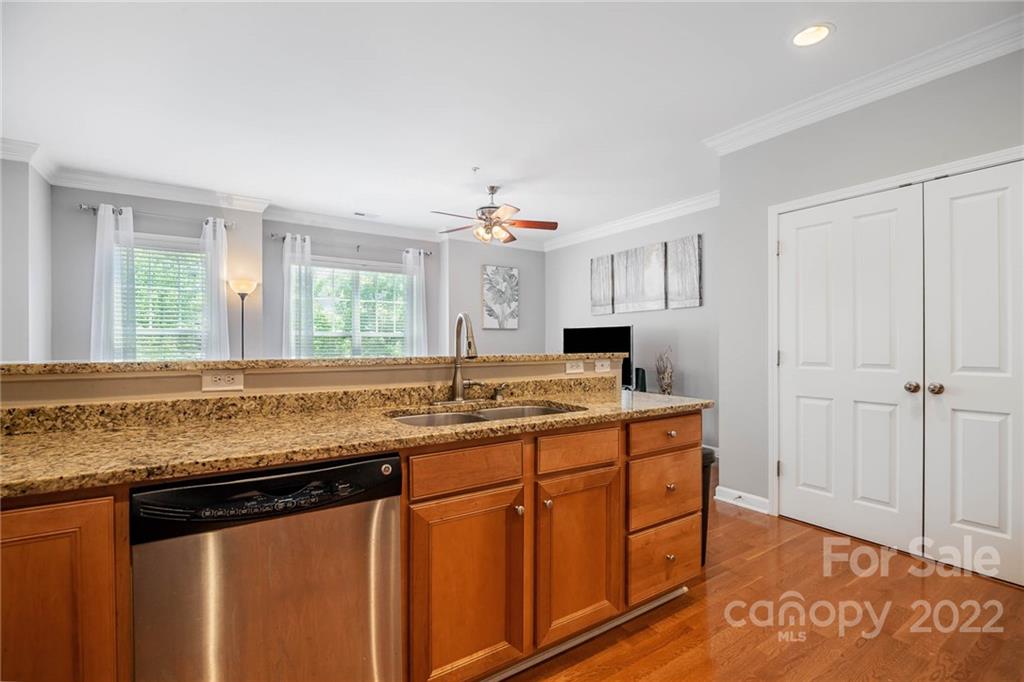 4156 Walker Road Charlotte, NC 28211 - Photo 10 of 24 a kitchen with stainless steel appliances granite countertop a sink and wooden cabinets