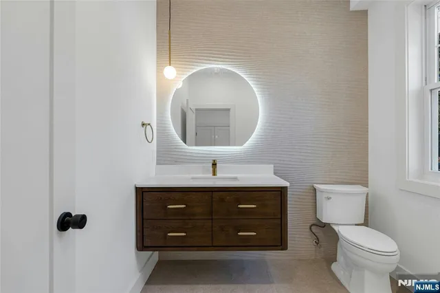 a bathroom with a toilet sink and mirror