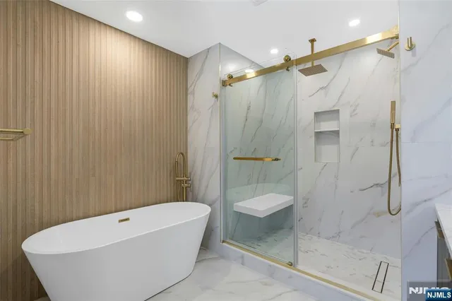 a bathroom with a bathtub and shower