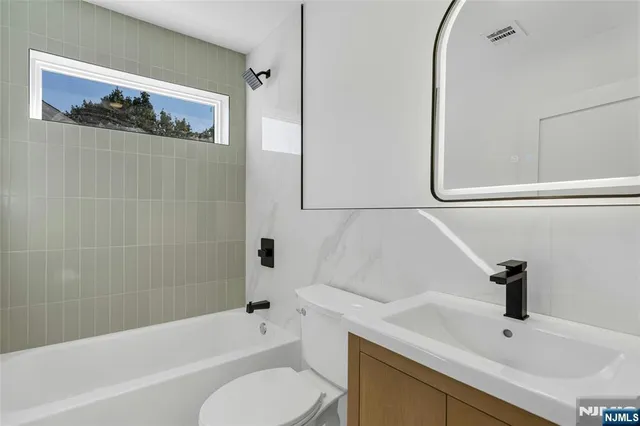 a bathroom with a sink a toilet and bathtub