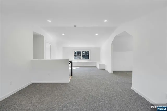 an empty room with windows and pillars in it