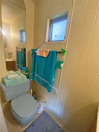 a bathroom with a sink toilet and mirror