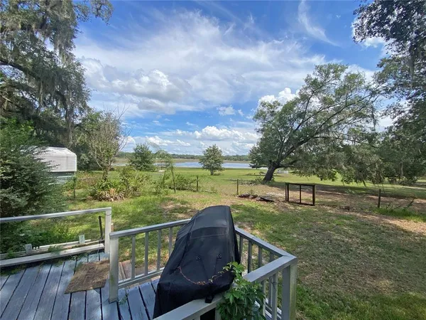 a view of a terrace with couches and wooden fence
