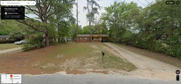 a view of a backyard with trees