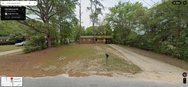 a view of a backyard with trees