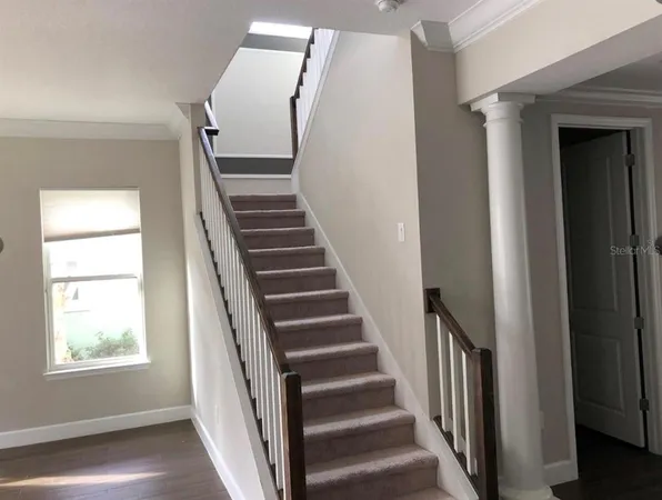 a view of an entryway with wooden floor