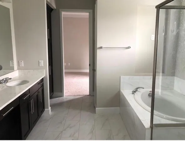 a bathroom with a bathtub and a sink