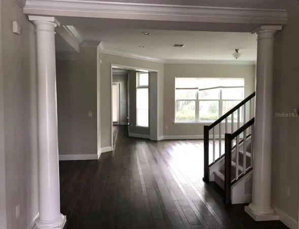 a view of an entryway with wooden floor and door