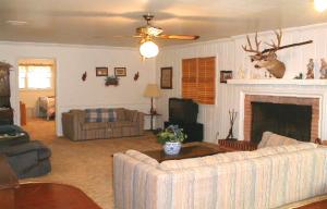 6024 Ward Street Amarillo, TX 79110 - Photo 2 of 5 a bedroom with a bed a couch and dresser