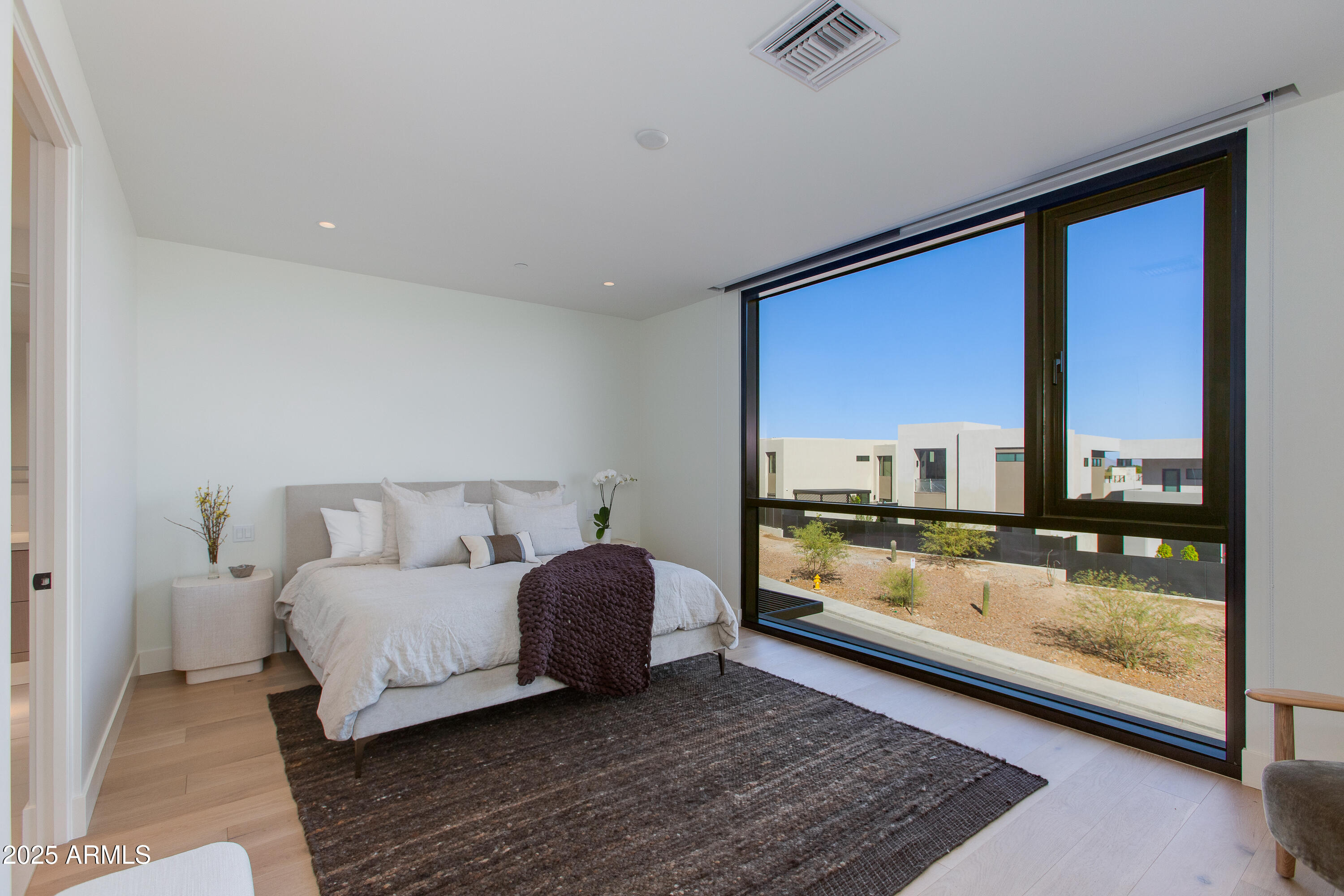 5000 North Camelback Ridge Drive, Unit 206 Scottsdale, AZ 85251 - Photo 23 of 62 a living room with a bed furniture and a large window