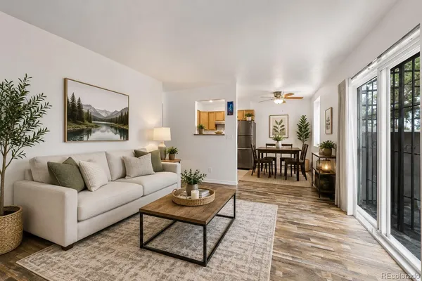 a living room with furniture and a wooden floor