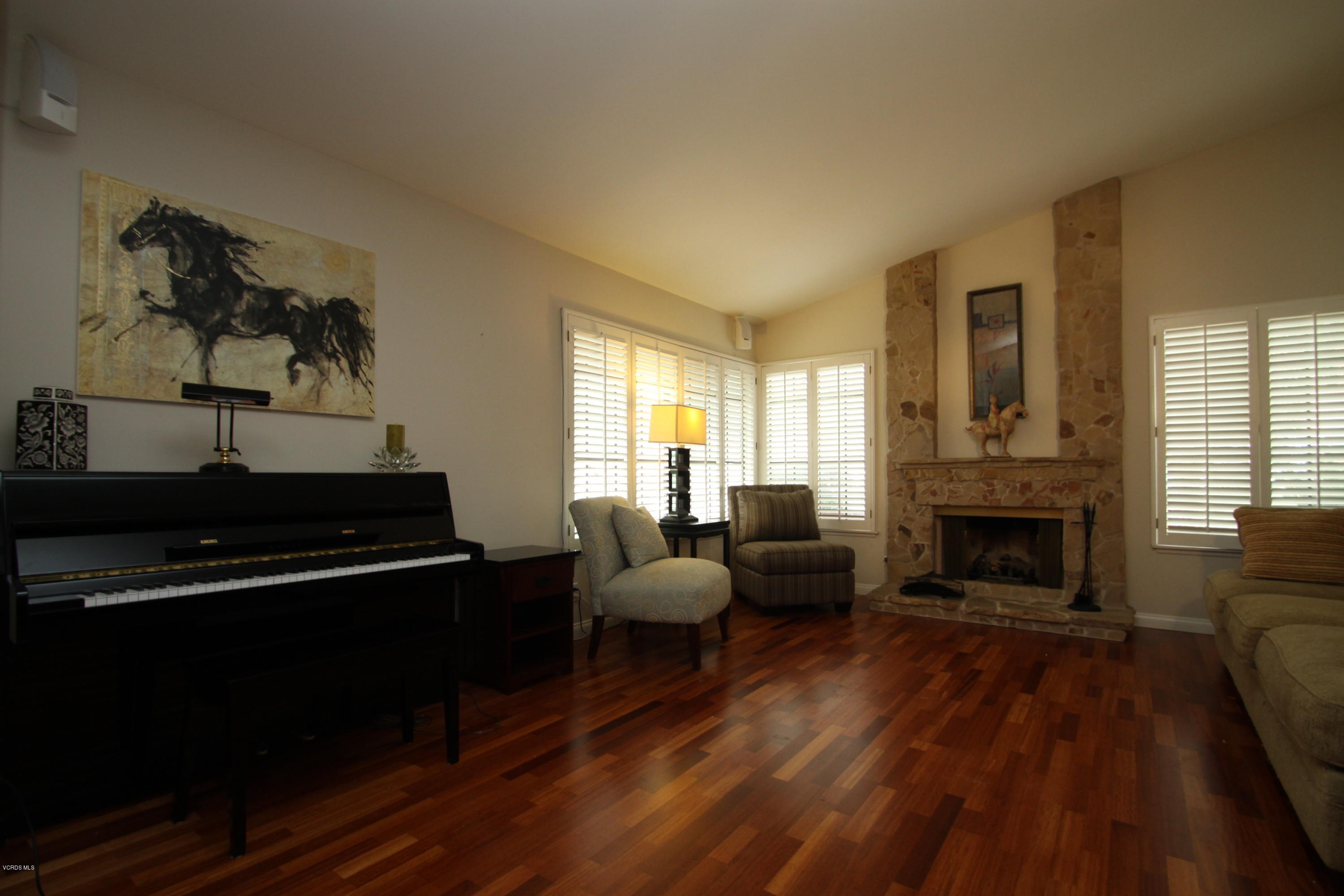 13638 Bear Valley Road Moorpark, CA 93021 - Photo 2 of 18 a living room with furniture a fireplace and a window