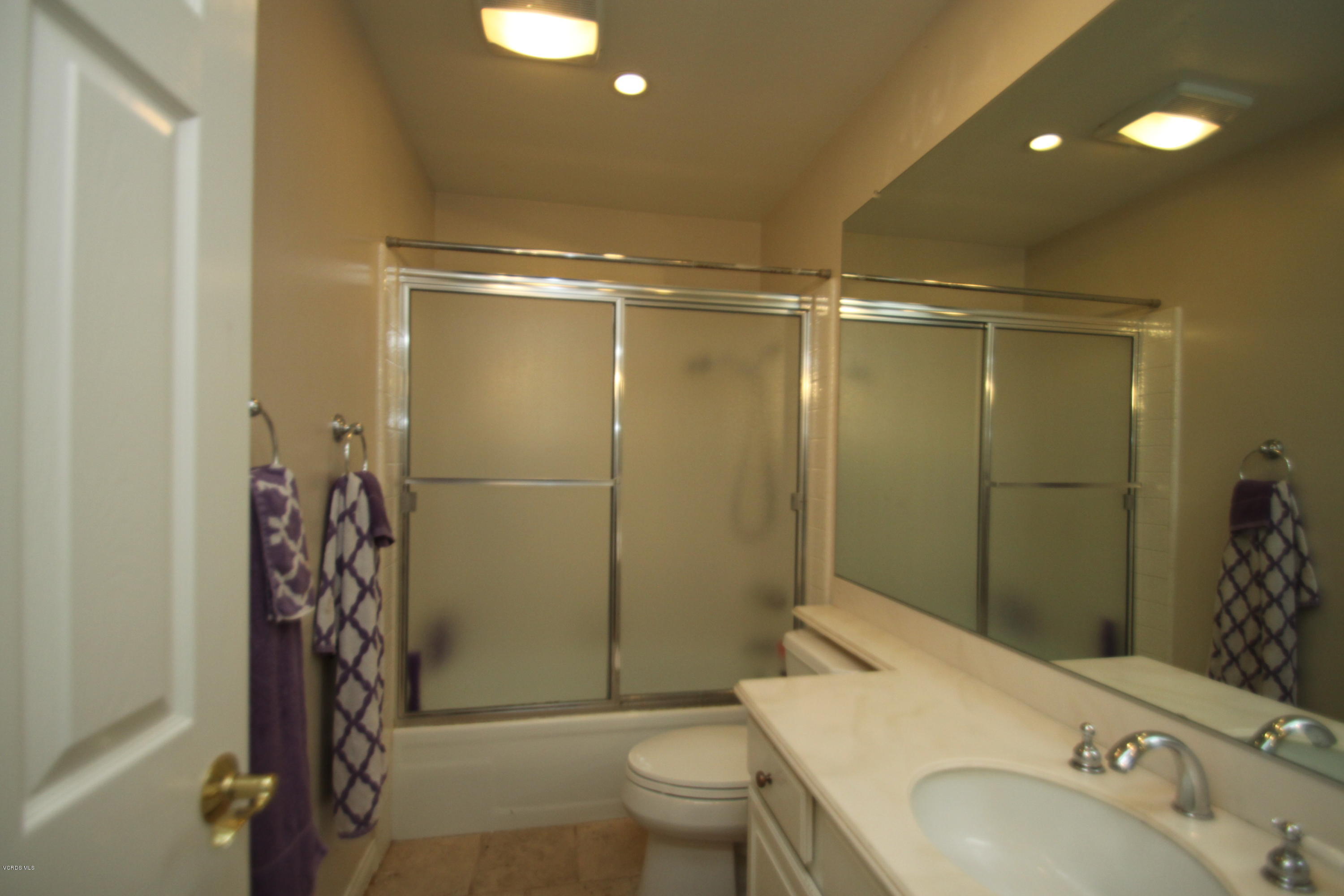 13638 Bear Valley Road Moorpark, CA 93021 - Photo 16 of 18 a bathroom with a shower and a toilet