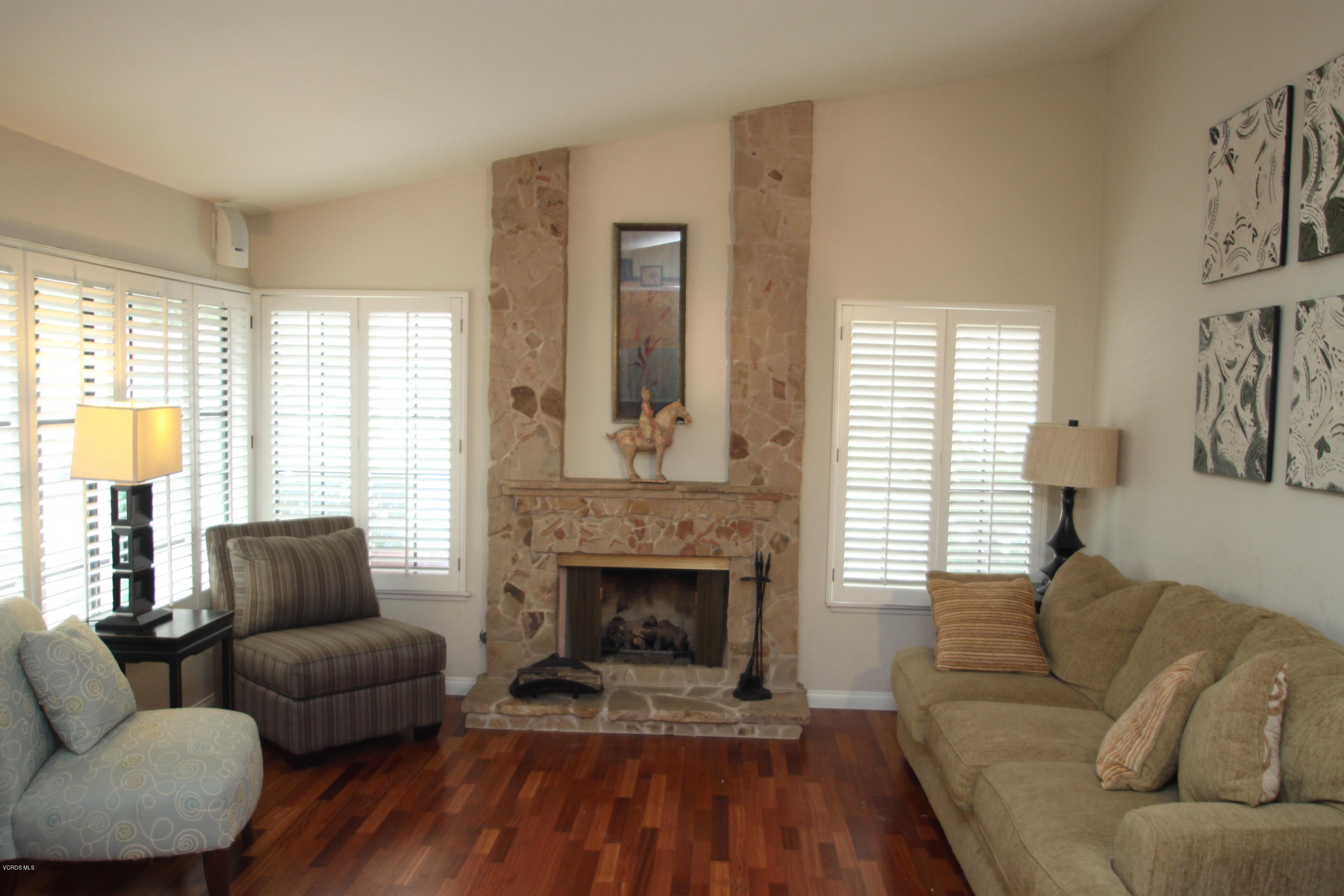 13638 Bear Valley Road Moorpark, CA 93021 - Photo 3 of 18 a living room with furniture and a fireplace
