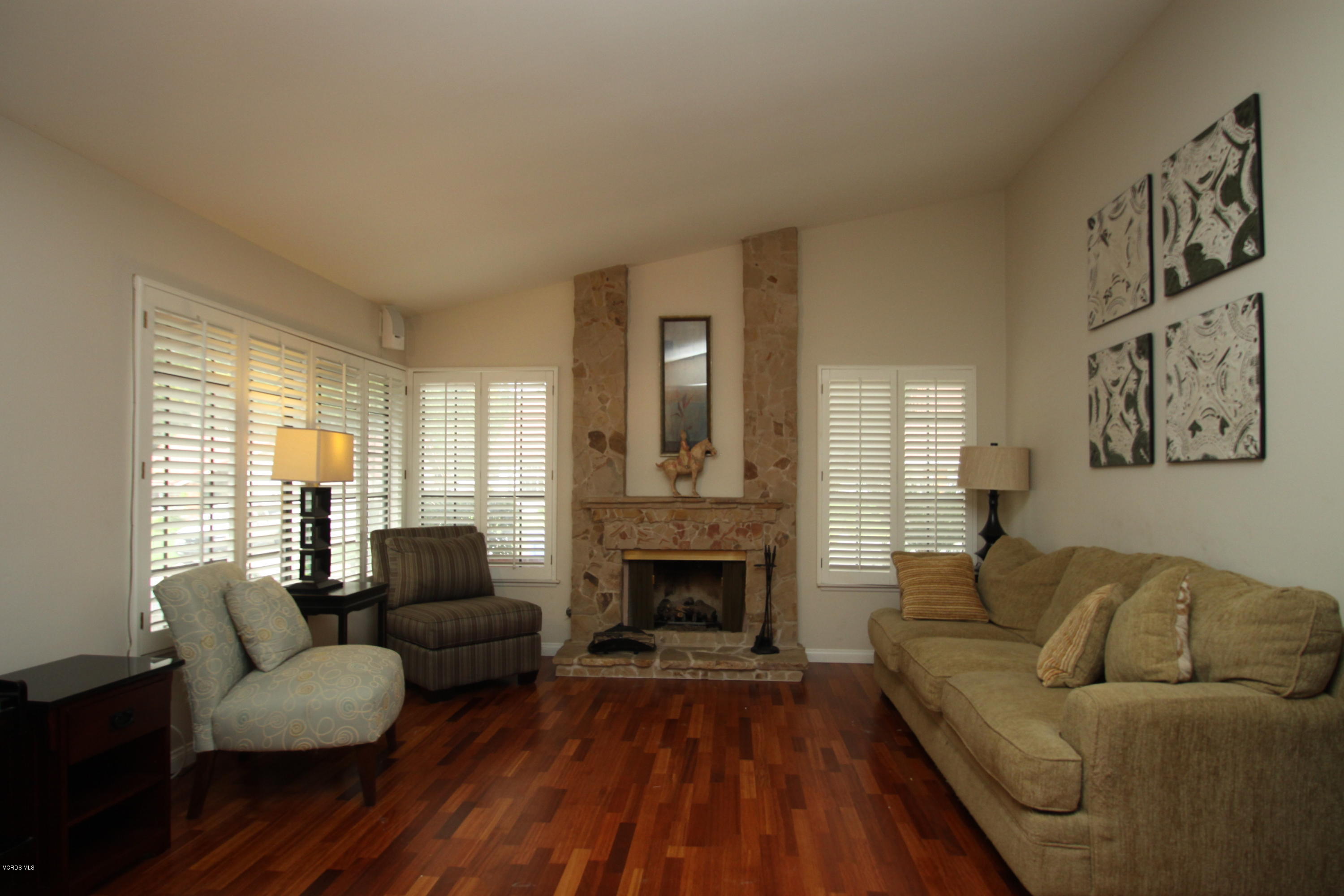 13638 Bear Valley Road Moorpark, CA 93021 - Photo 5 of 18 a living room with furniture and a fireplace