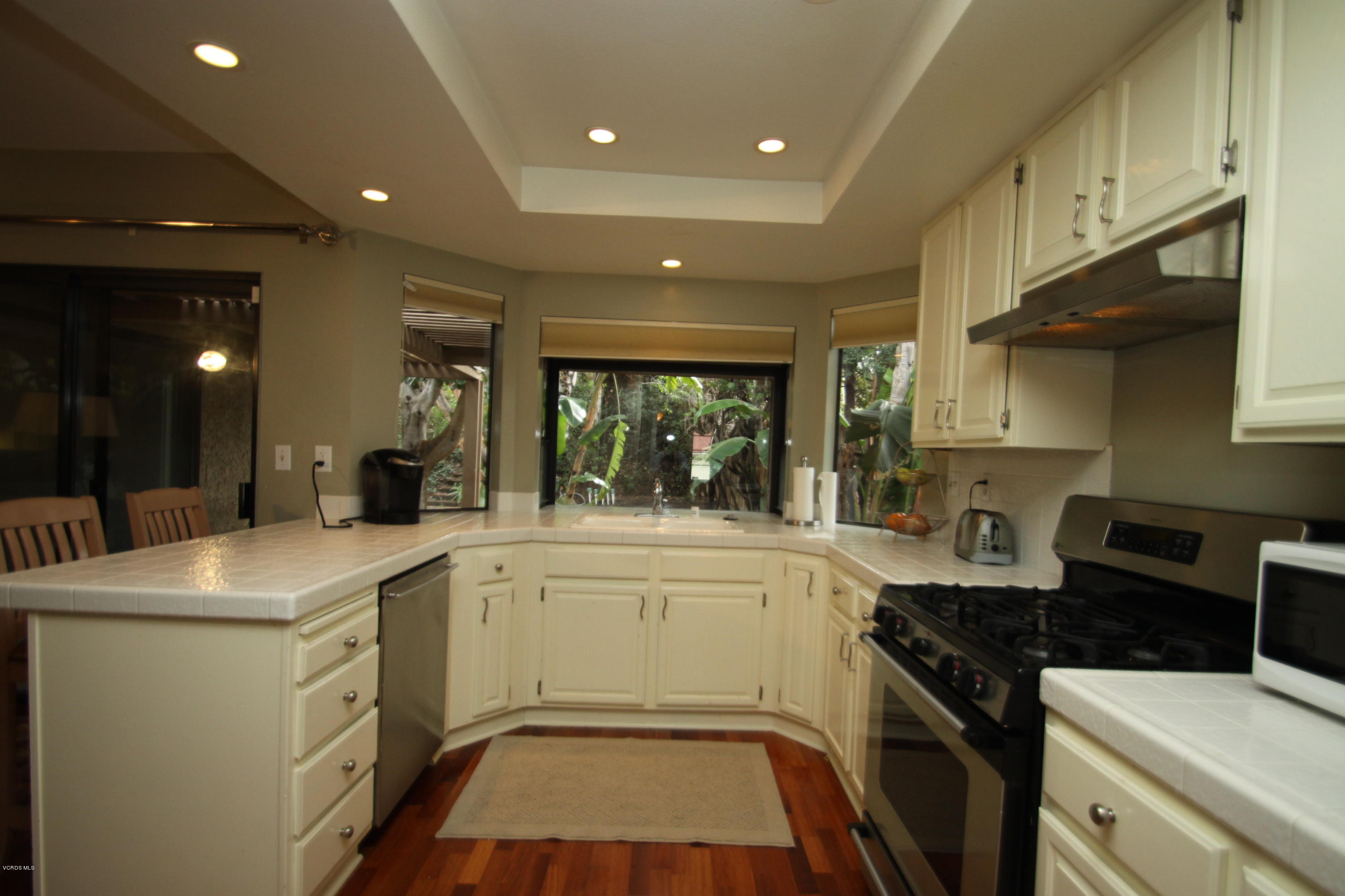 13638 Bear Valley Road Moorpark, CA 93021 - Photo 6 of 18 a kitchen that has a sink and a stove in it