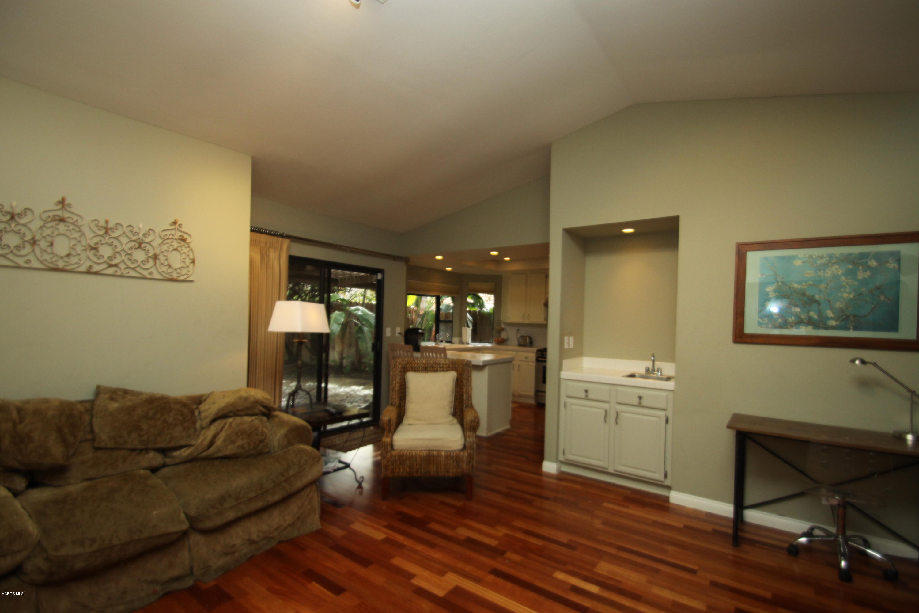 13638 Bear Valley Road Moorpark, CA 93021 - Photo 10 of 18 a living room with a couch and a dining table with wooden floor