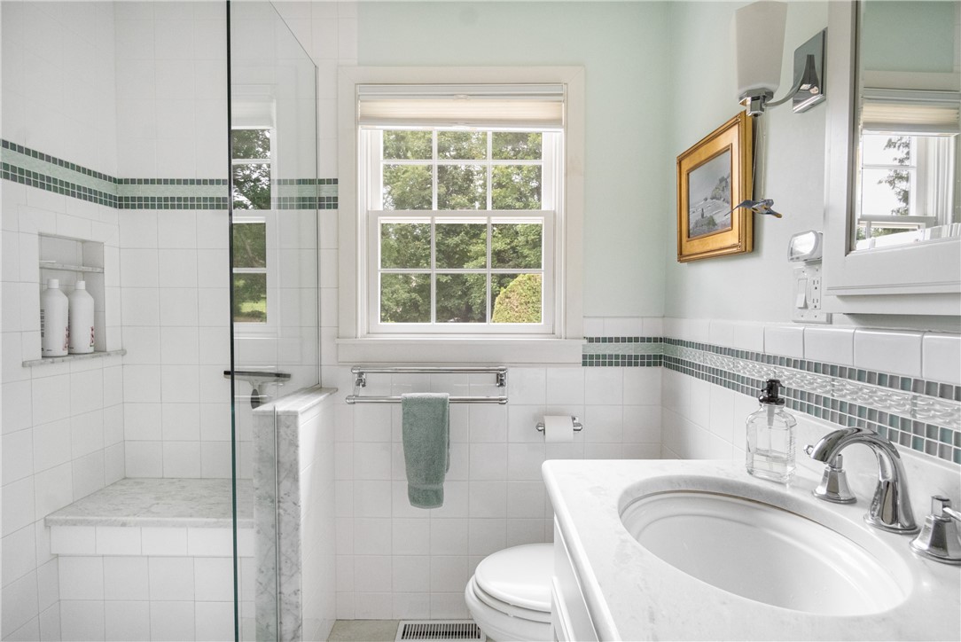 16 Circle Drive Middletown, RI 02842 - Photo 27 of 40 Connecting ensuite Bathroom has stunning mint marble counters and floors, and glass-enclosed shower with built-in seat and floor to ceiling tile.