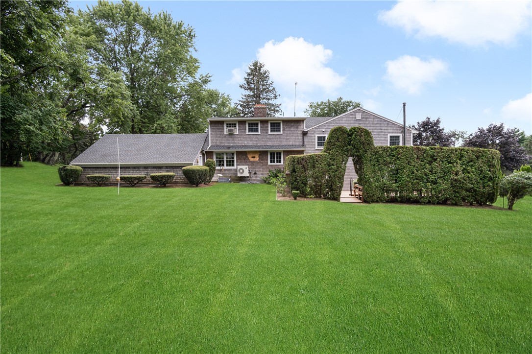 16 Circle Drive Middletown, RI 02842 - Photo 6 of 40 Spacious greenspace around back of house, lush lawn well-maintained