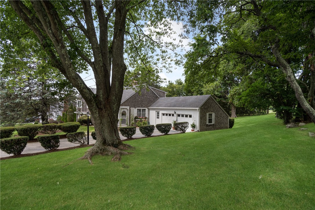 16 Circle Drive Middletown, RI 02842 - Photo 8 of 40 Beautiful maple tree stands tall in side yard. Row of trees border the top of property along the street of this corner lot.