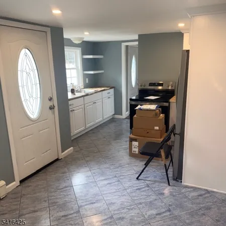 a kitchen with stainless steel appliances a refrigerator and a stove top oven