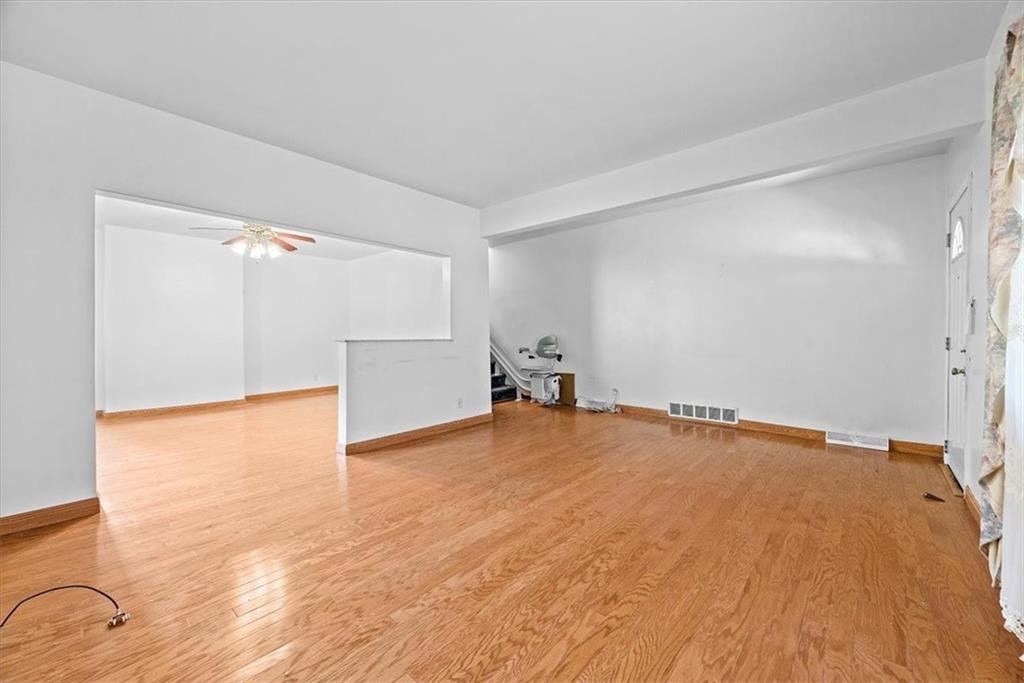 915 1st Street McKees Rocks, PA 15136 - Photo 16 of 25 a view of an empty room with wooden floor