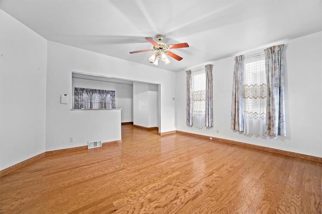 915 1st Street McKees Rocks, PA 15136 - Photo 18 of 25 a view of an empty room with window and wooden floor