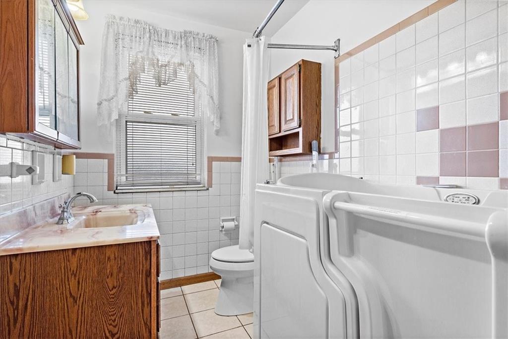 915 1st Street McKees Rocks, PA 15136 - Photo 19 of 25 a bathroom with a sink toilet and shower