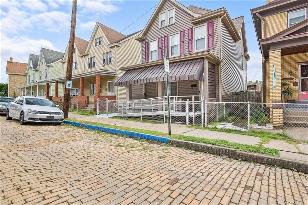 915 1st Street McKees Rocks, PA 15136 - Photo 2 of 25 a view of a house with a yard and more windows