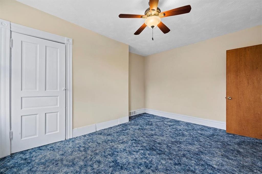915 1st Street McKees Rocks, PA 15136 - Photo 24 of 25 an empty room with closet and a chandelier fan