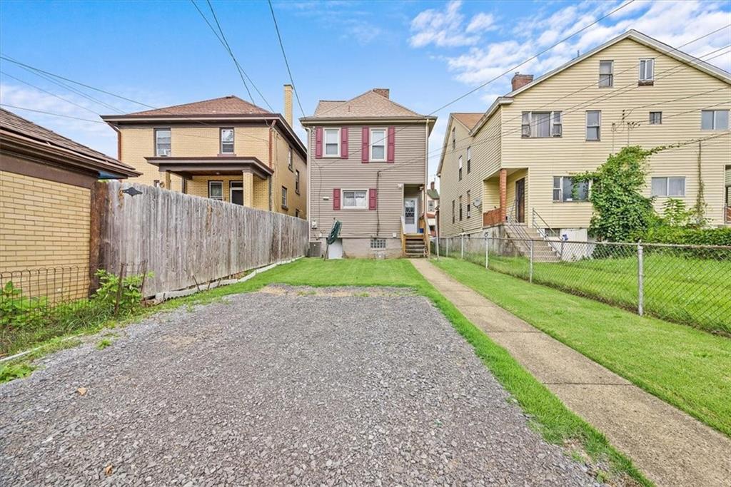 915 1st Street McKees Rocks, PA 15136 - Photo 7 of 25 a front view of a house with a yard and garage