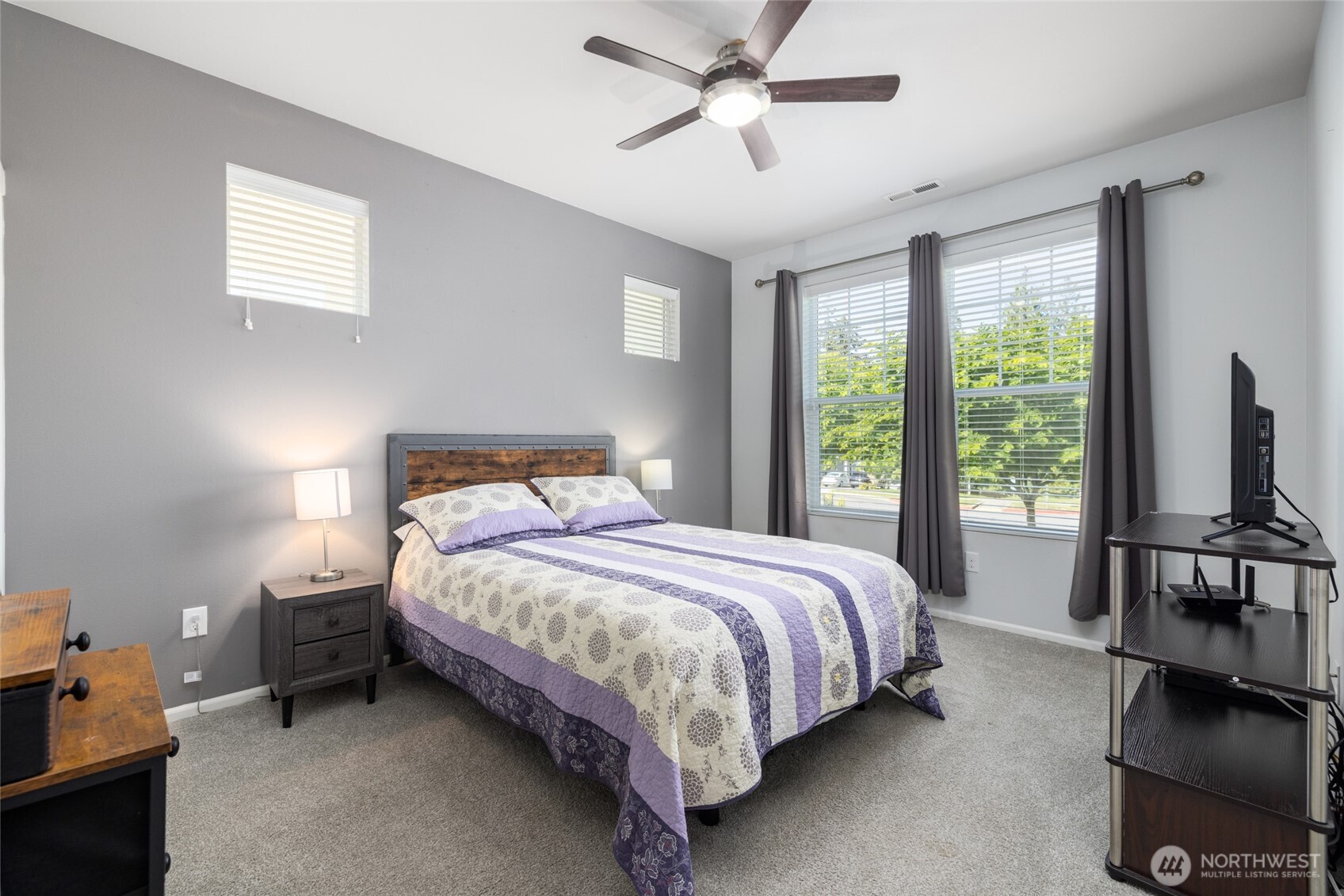 232 Sinclair Alley Mount Vernon, WA 98274 - Photo 13 of 33 a bedroom with a bed a flat screen tv and a large window