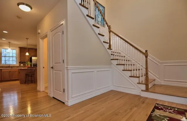 a view of entryway and hall with wooden floor