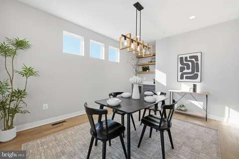 a view of a dining room with furniture window and wooden floor
