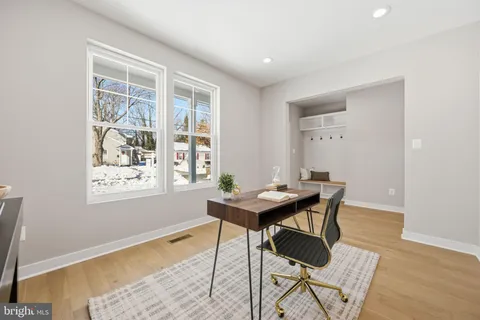 a view of a workspace room with furniture and wooden floor